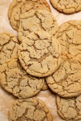 Peanut Butter Snickerdoodle Cookies stacked on parchment paper