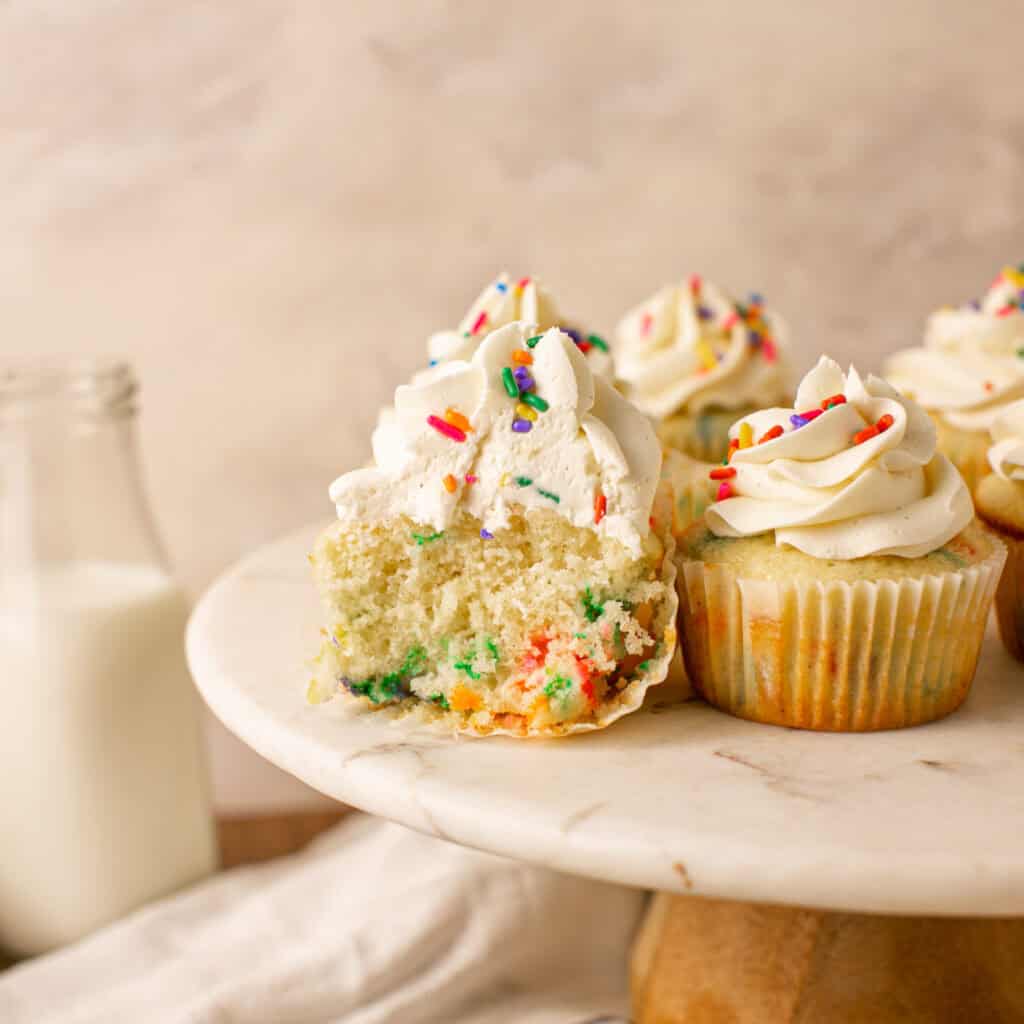 A cut cupcake to show the sprinkles on the inside of the cake.