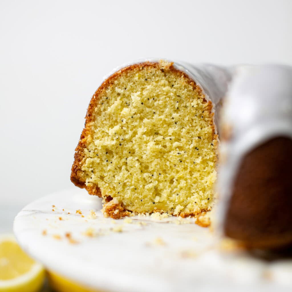 A slice of the bundt cake to show the lemon poppyseeds