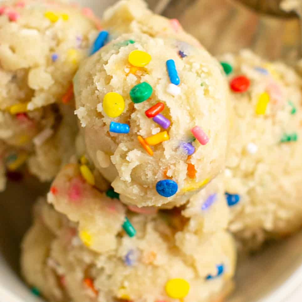 a close up shot of the sprinkles on top of the no bake sugar cookie dough