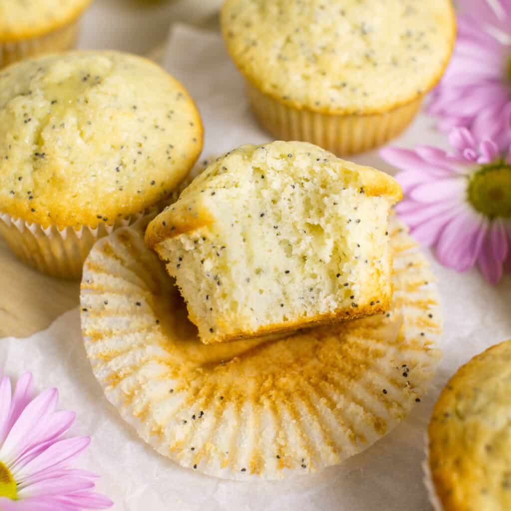 A picture showing a bite taken out of the lemon poppyseed muffins