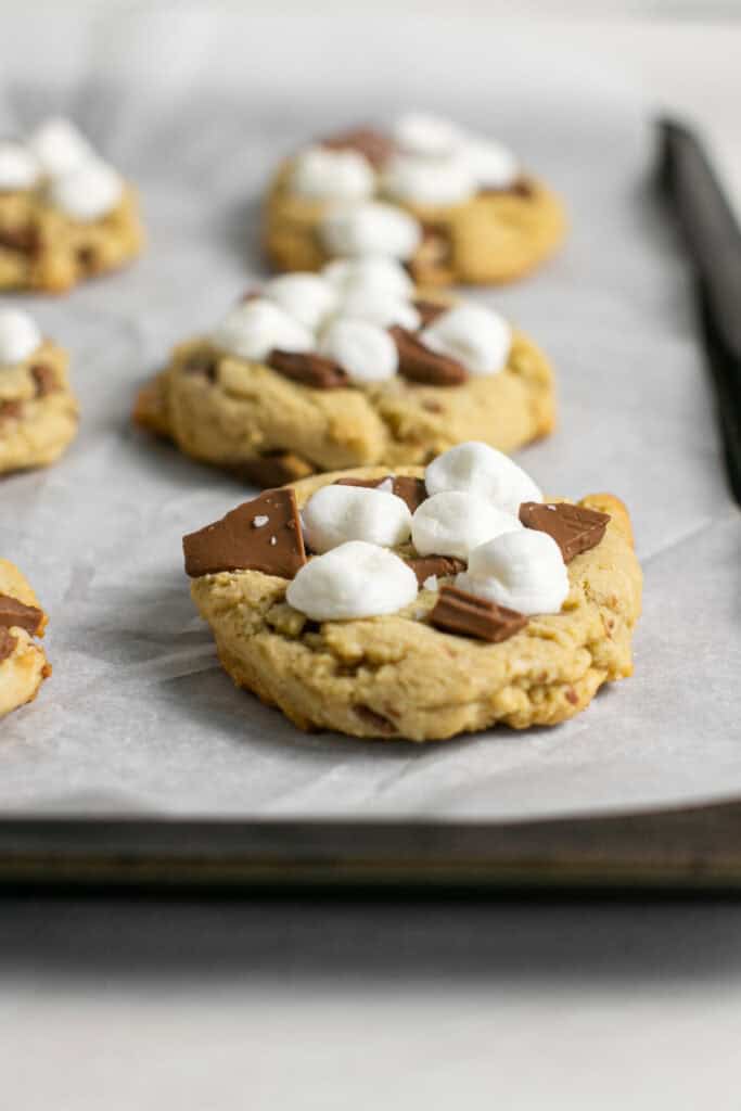 A picture of the s'mores cookies sitting on the baking sheet.