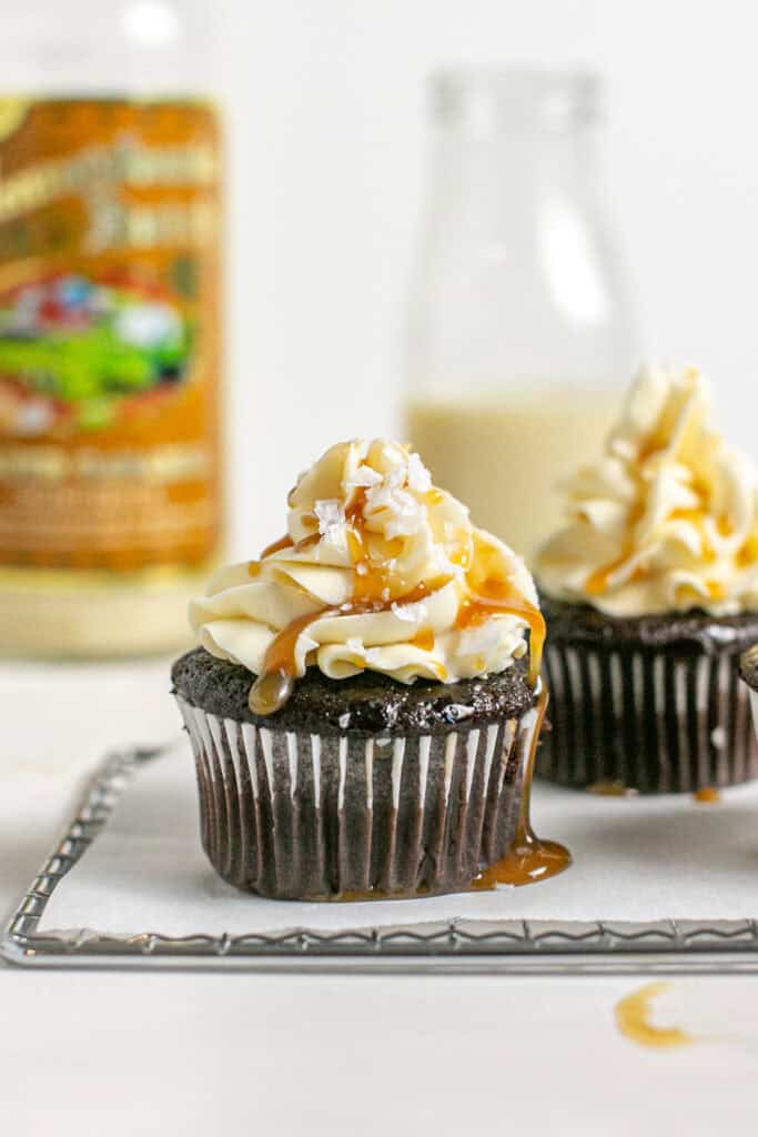 A picture of the salted caramel cupcakes with a pinch of flakey salt on top.