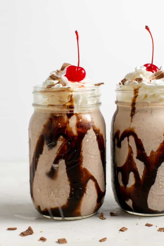 A picture of the nutella milkshake showing off the chocolate drizzle, whipped cream and cherry.