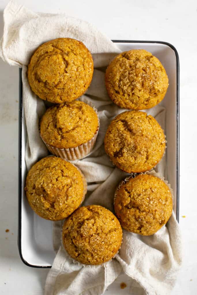 A bunch of pumpkin spice muffins are sitting in a pan.