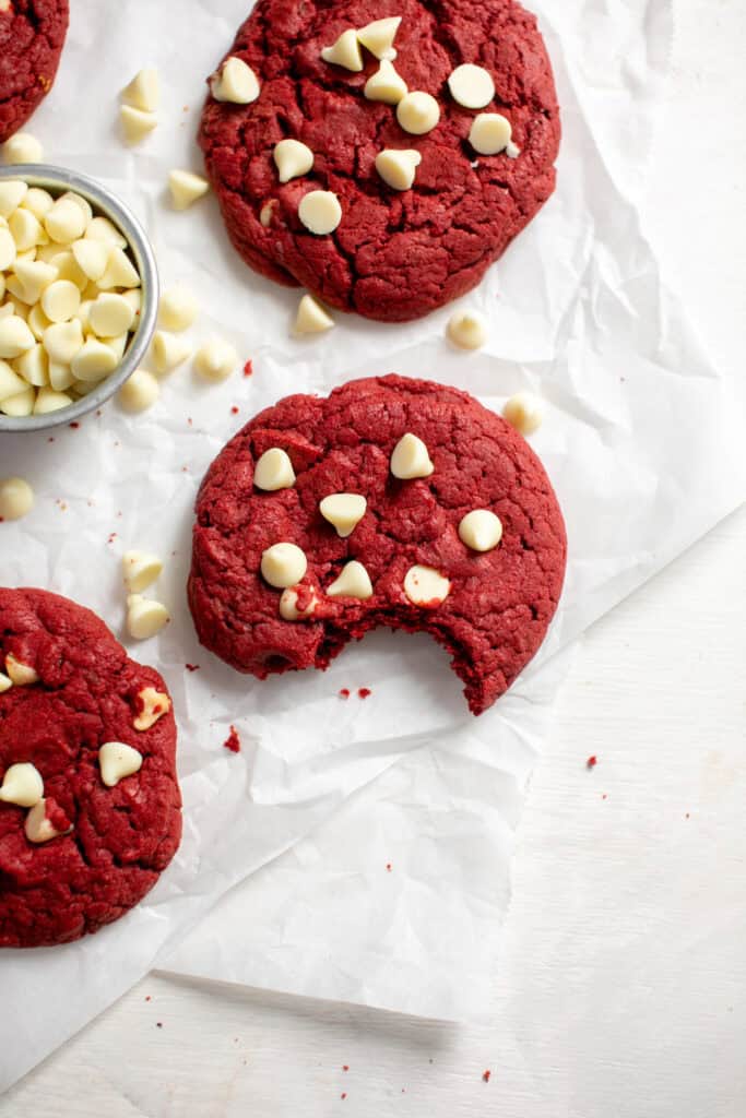 an overhead shot of the red velvet cookies with a bite taken out of one.