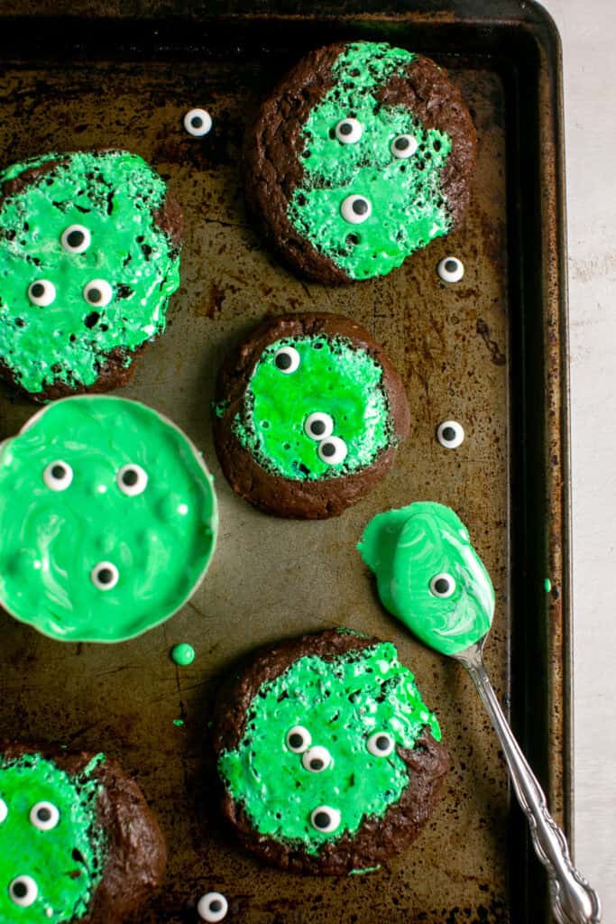 The gooey monster marshmallow cookies sitting on a sheet pan with the marshmallow slime.