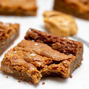 a close up picture showing a bite taken out of the peanut butter blondies