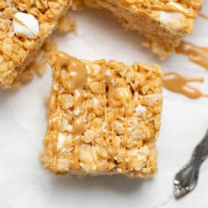 Peanut butter marshmallow bars sitting on a parchment paper.
