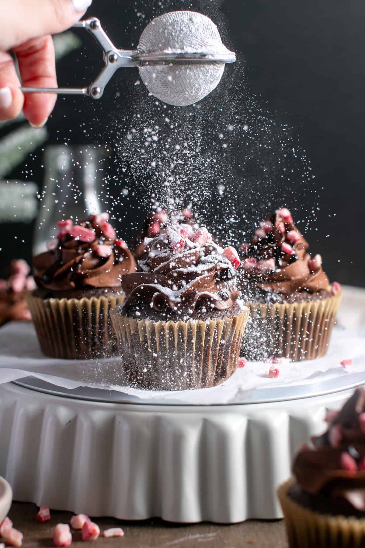 Chocolate mint cupcakes with a large sprinkle of powdered sugar. 