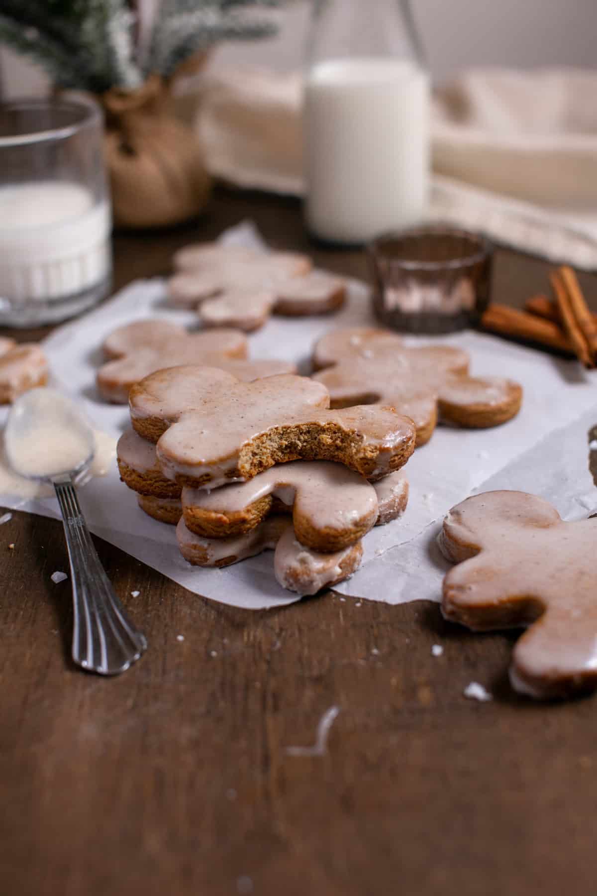 Gingerbread men stacked on parchment paper.