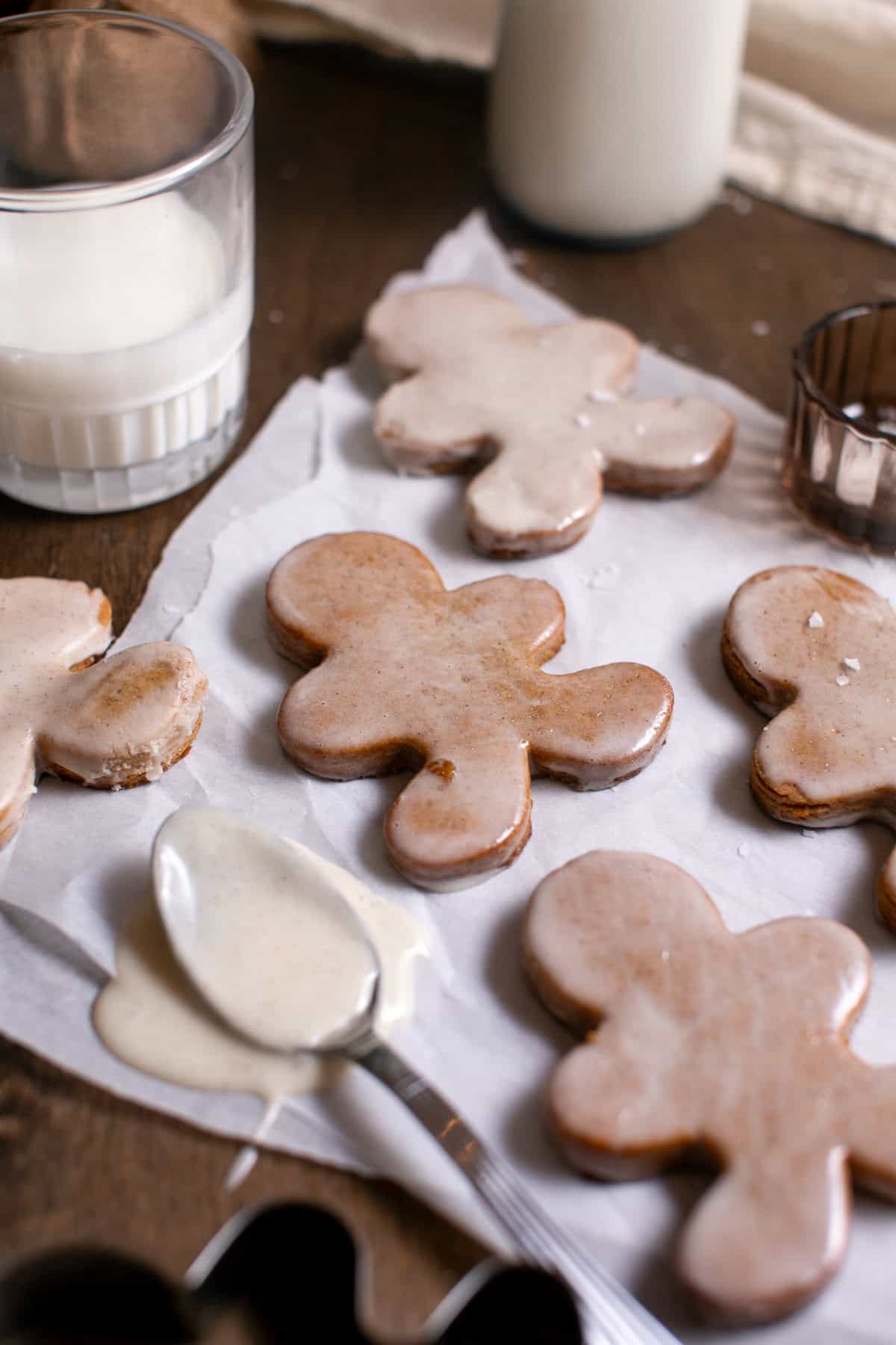 Gingerbread sitting by a glass of milk.