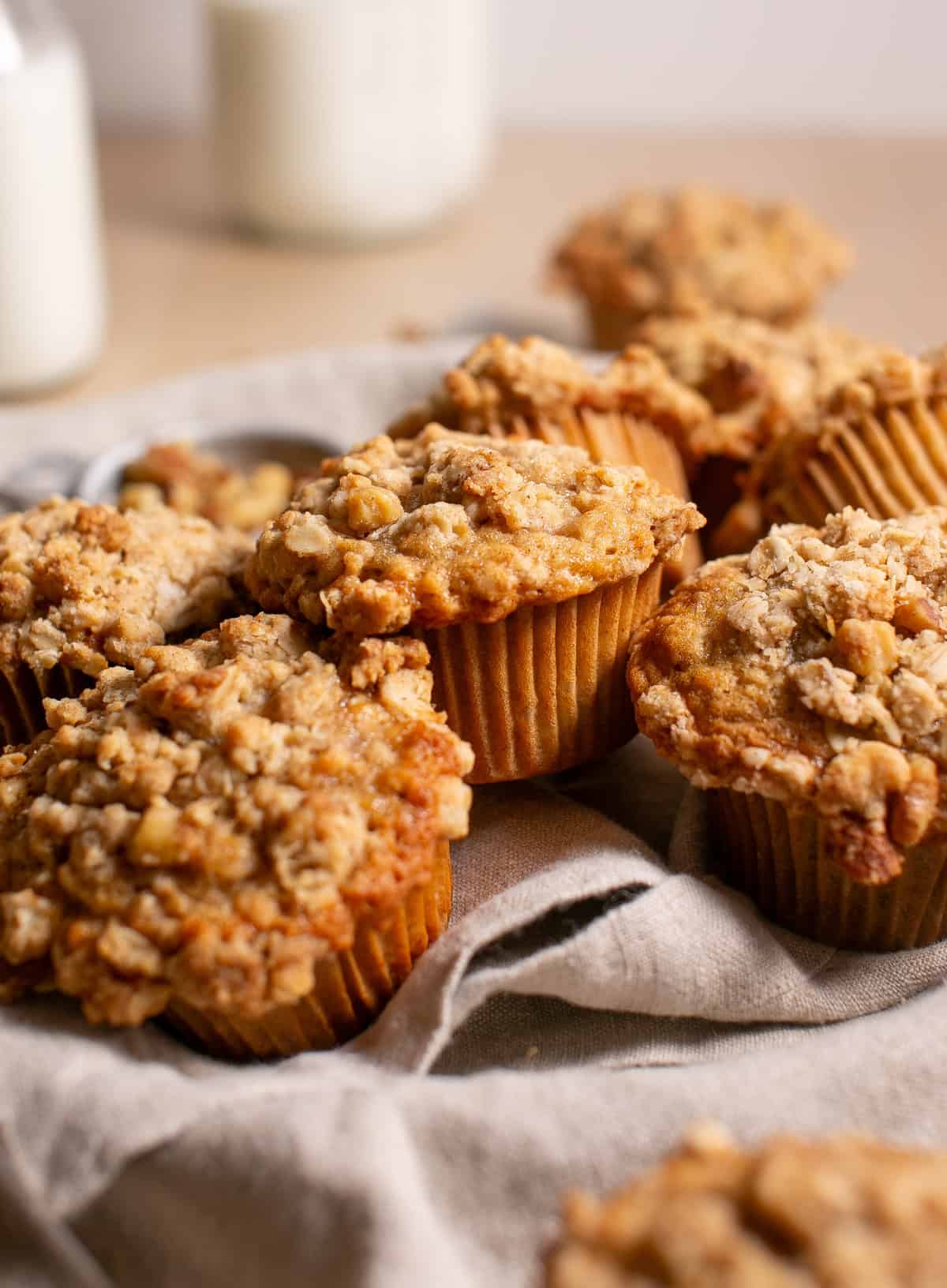 Banana Oat Muffins in a pile on a cloth napkin. 