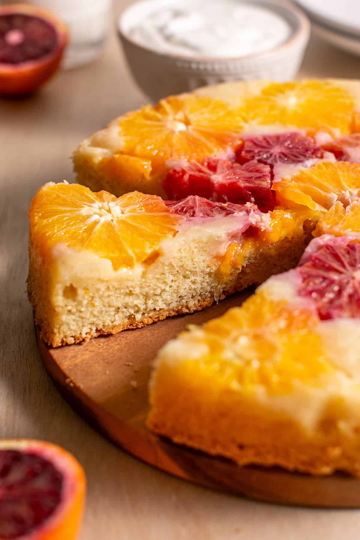 A slice cut out of a winter citrus cake. 