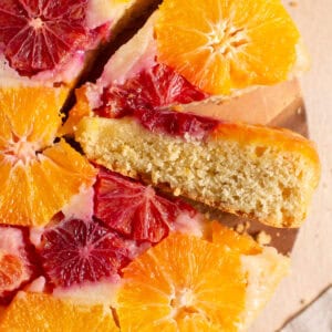 Two slices cut out of a winter citrus cake.