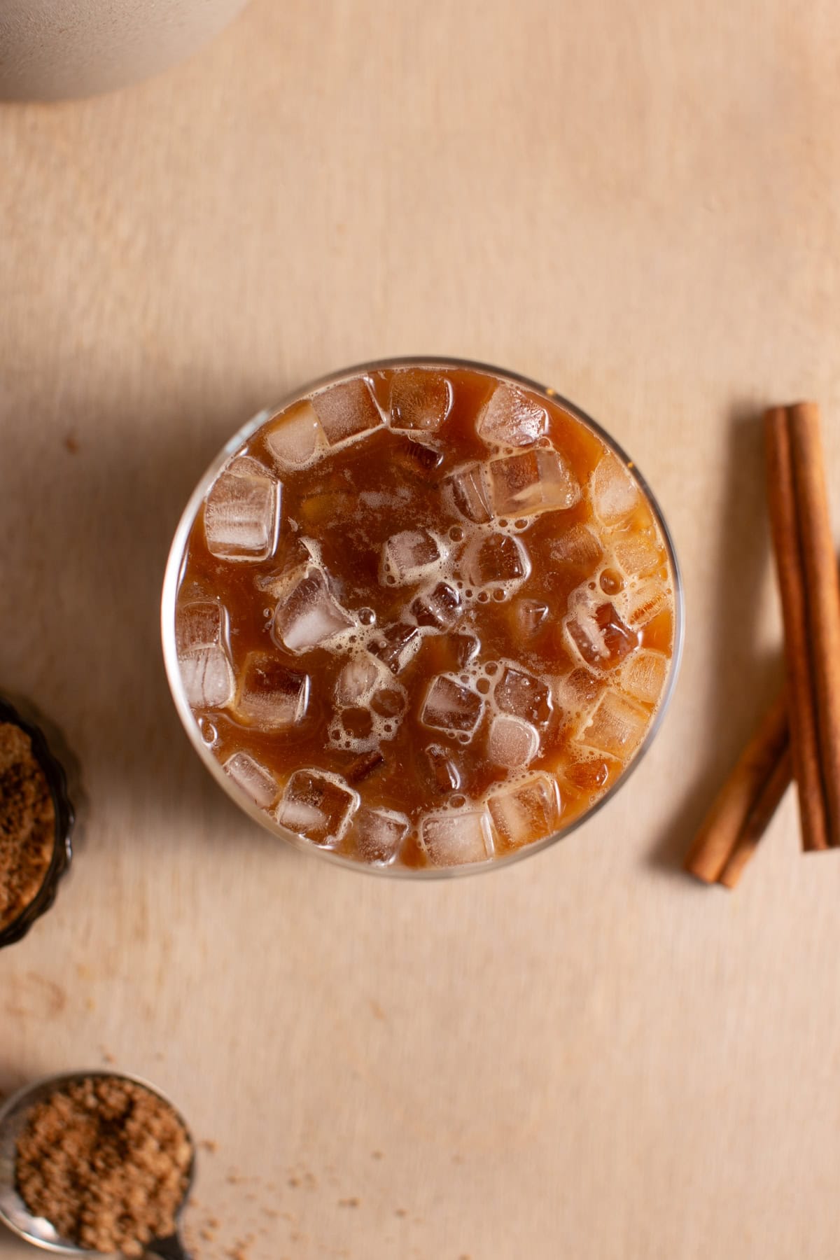 Overhead view of a glass of iced chai.