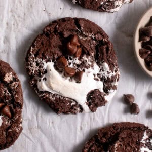 Hot chocolate Cookies sitting on parchment paper.