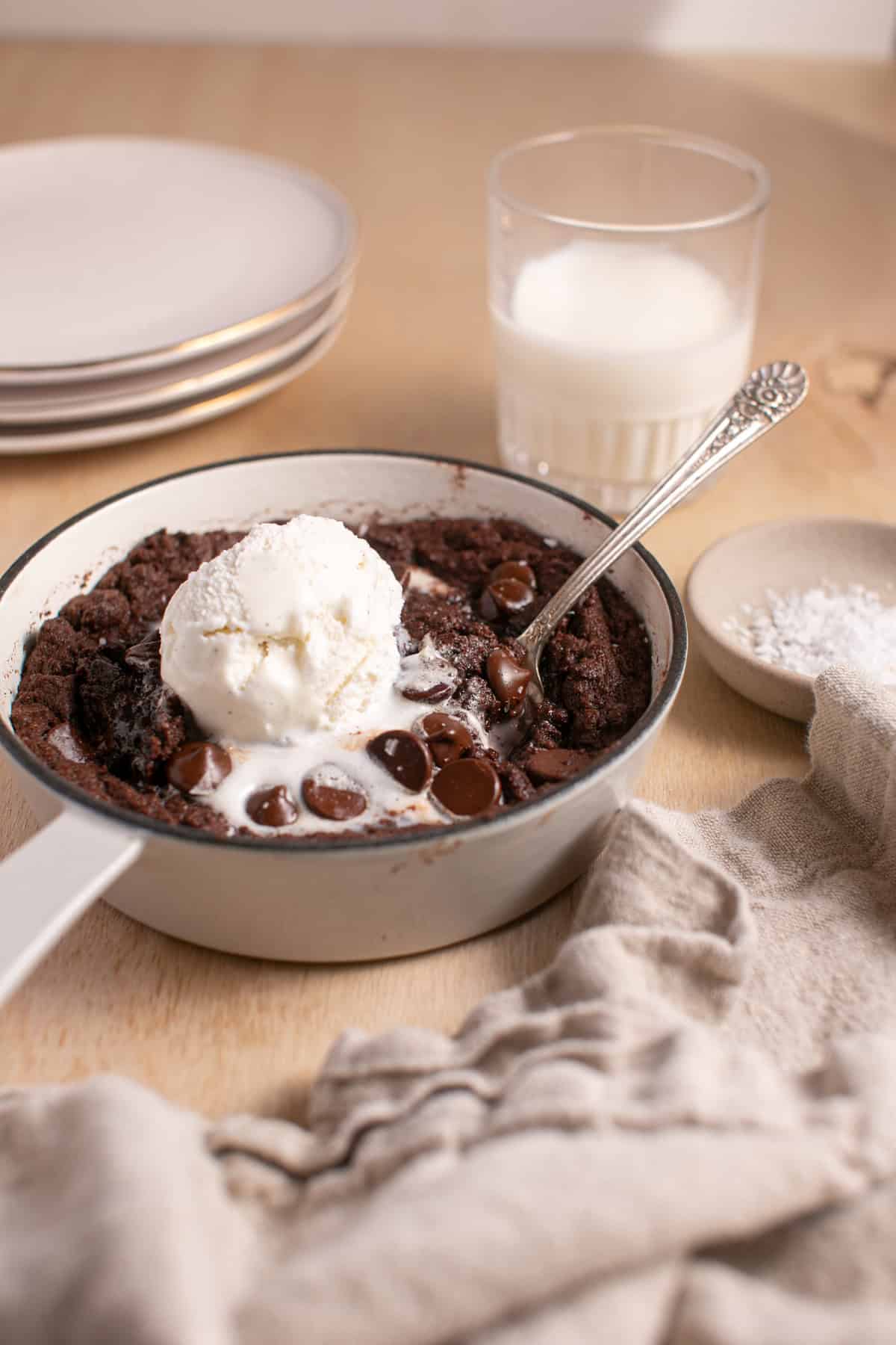 Double Chocolate Skillet Cookie by a glass of milk.