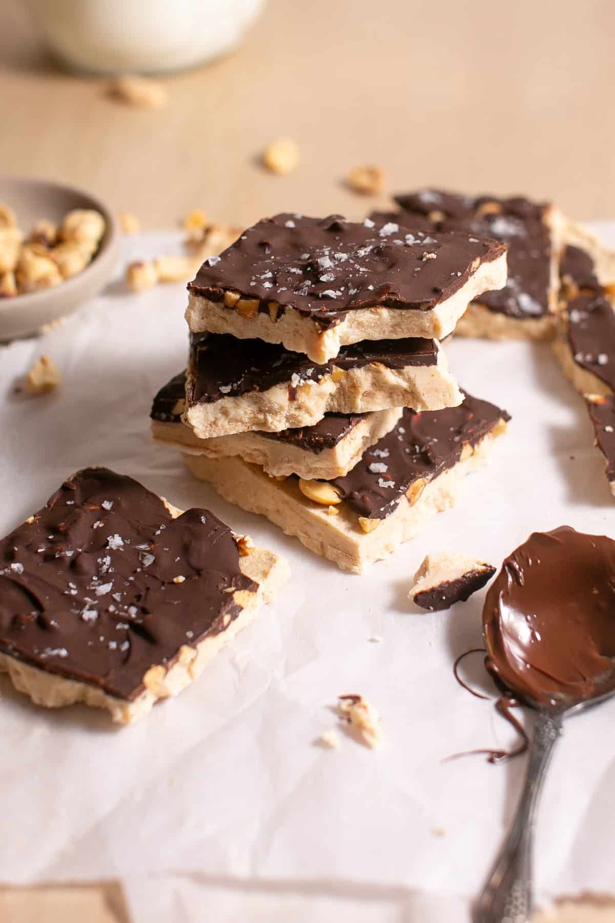 Peanut Butter Yogurt Bark stacked with a bite missing. 