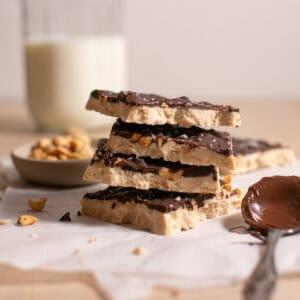 Peanut Butter Yogurt Bark stacked on parchment paper.