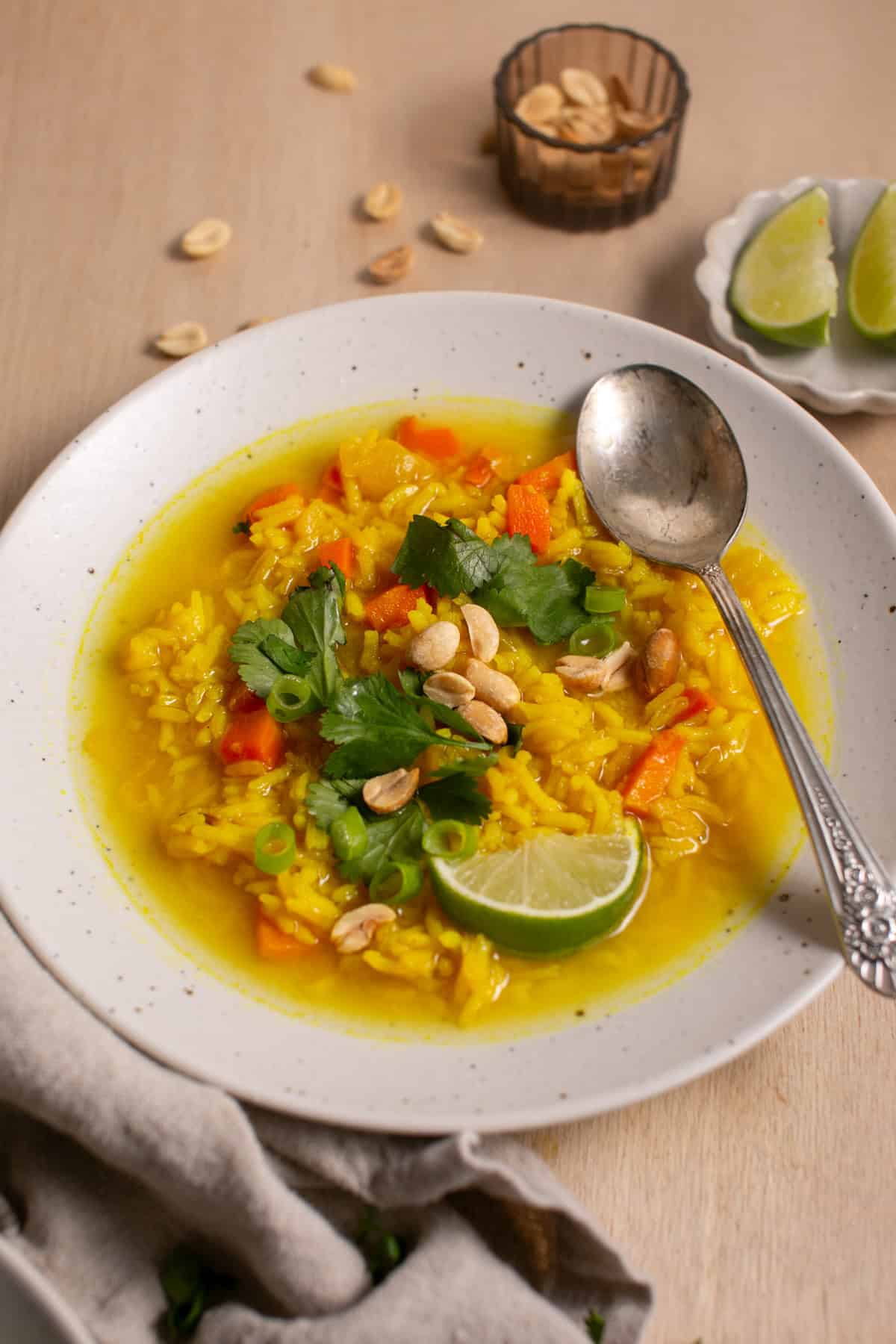 Feel-Good Turmeric Rice Soup with a spoon beside it. 