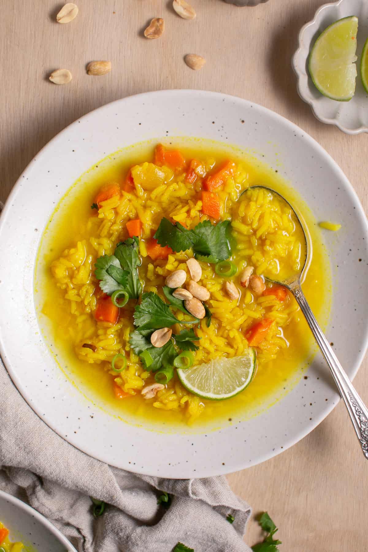 Feel-Good Turmeric Rice Soup with a spoon in the bowl.
