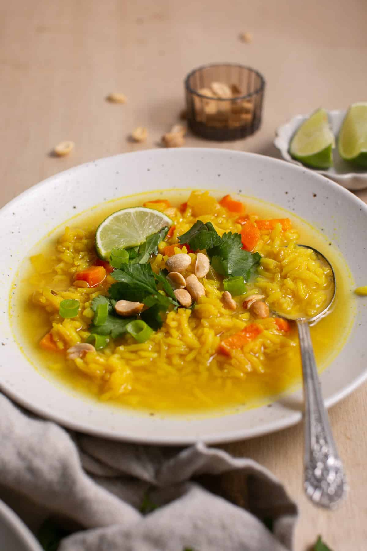 Feel-Good Turmeric Rice Soup with a garnish of cilantro and lime. 