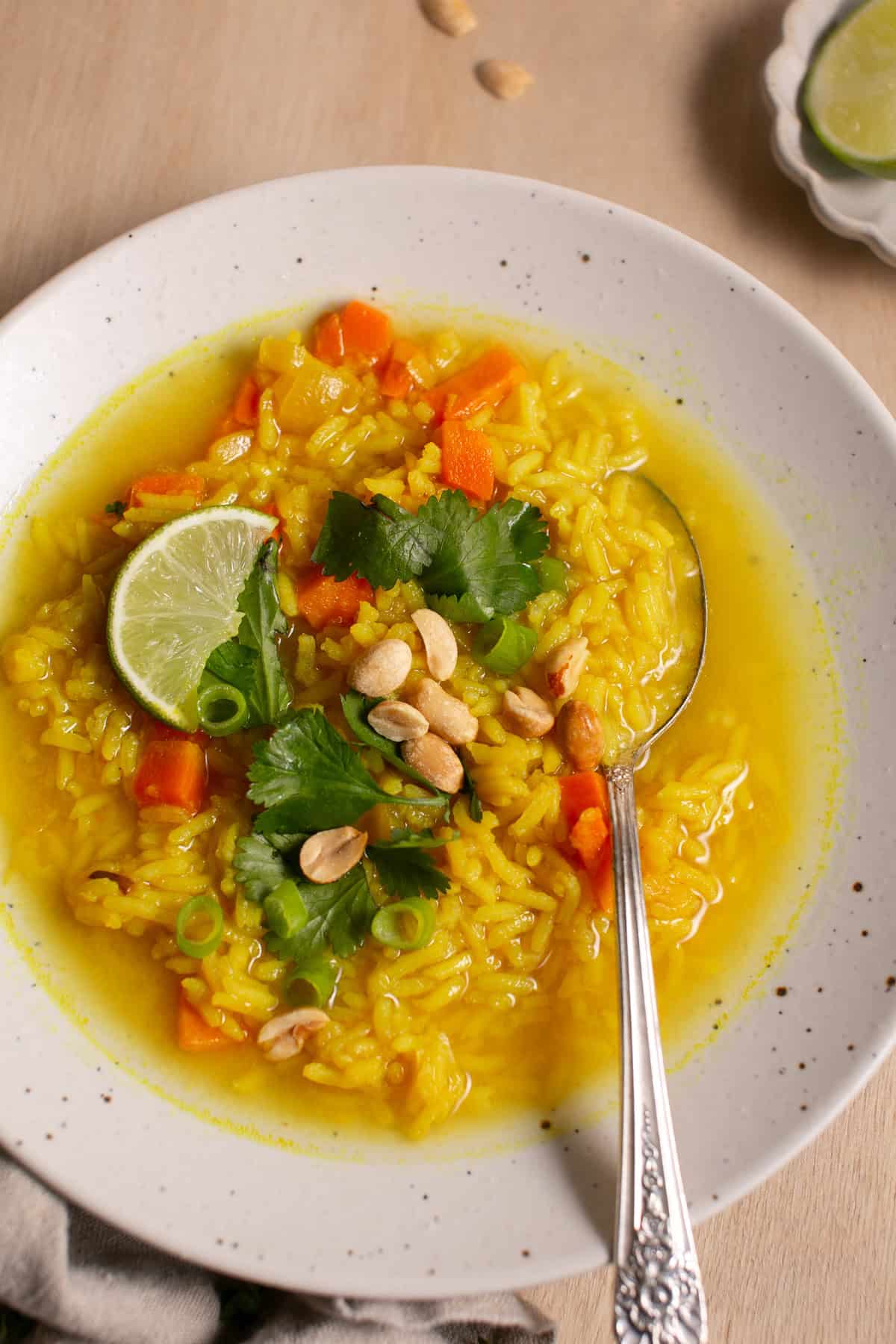 Feel-Good Turmeric Rice Soup with a spoon-full of rice. 