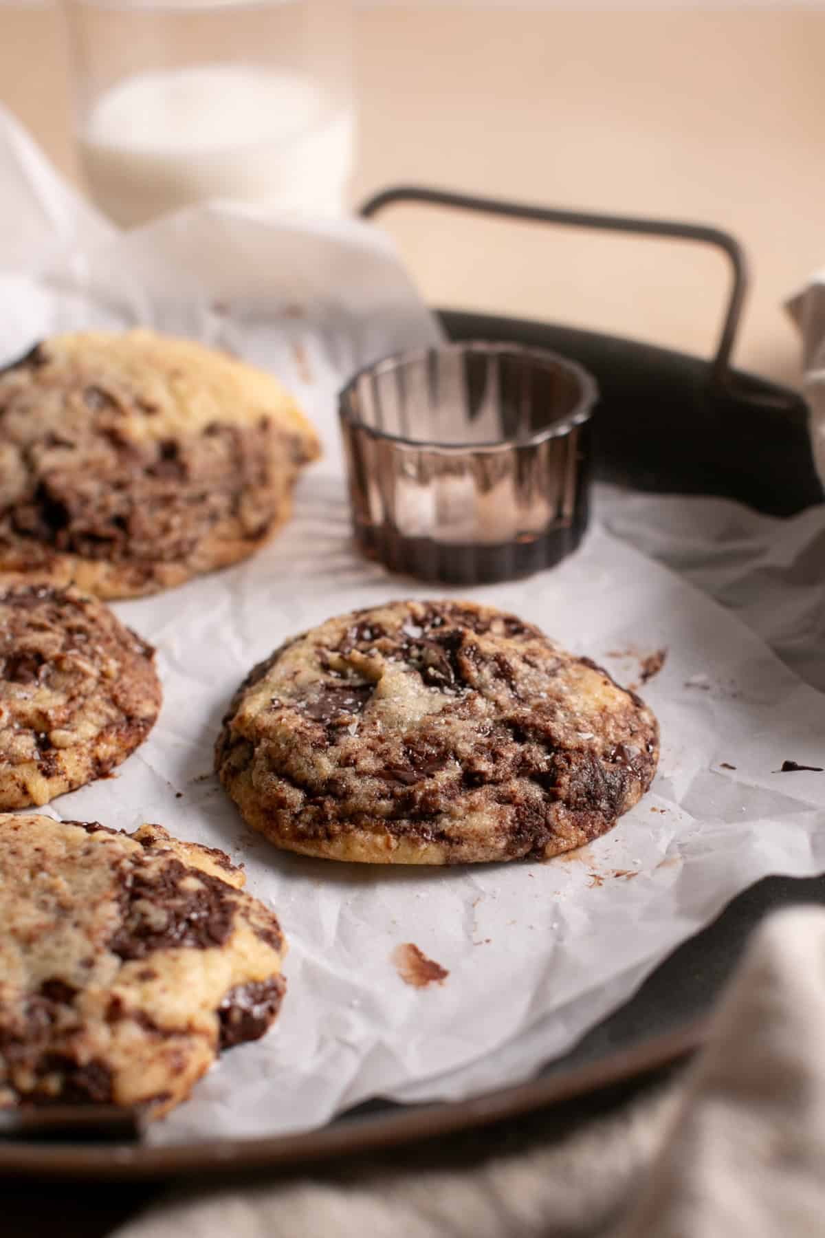 Chocolate Chip Brownie Cookies sitting on parchment paper. 
