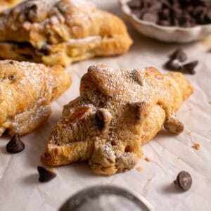 Chocolate Chip Cookie Croissant sitting on parchment paper.