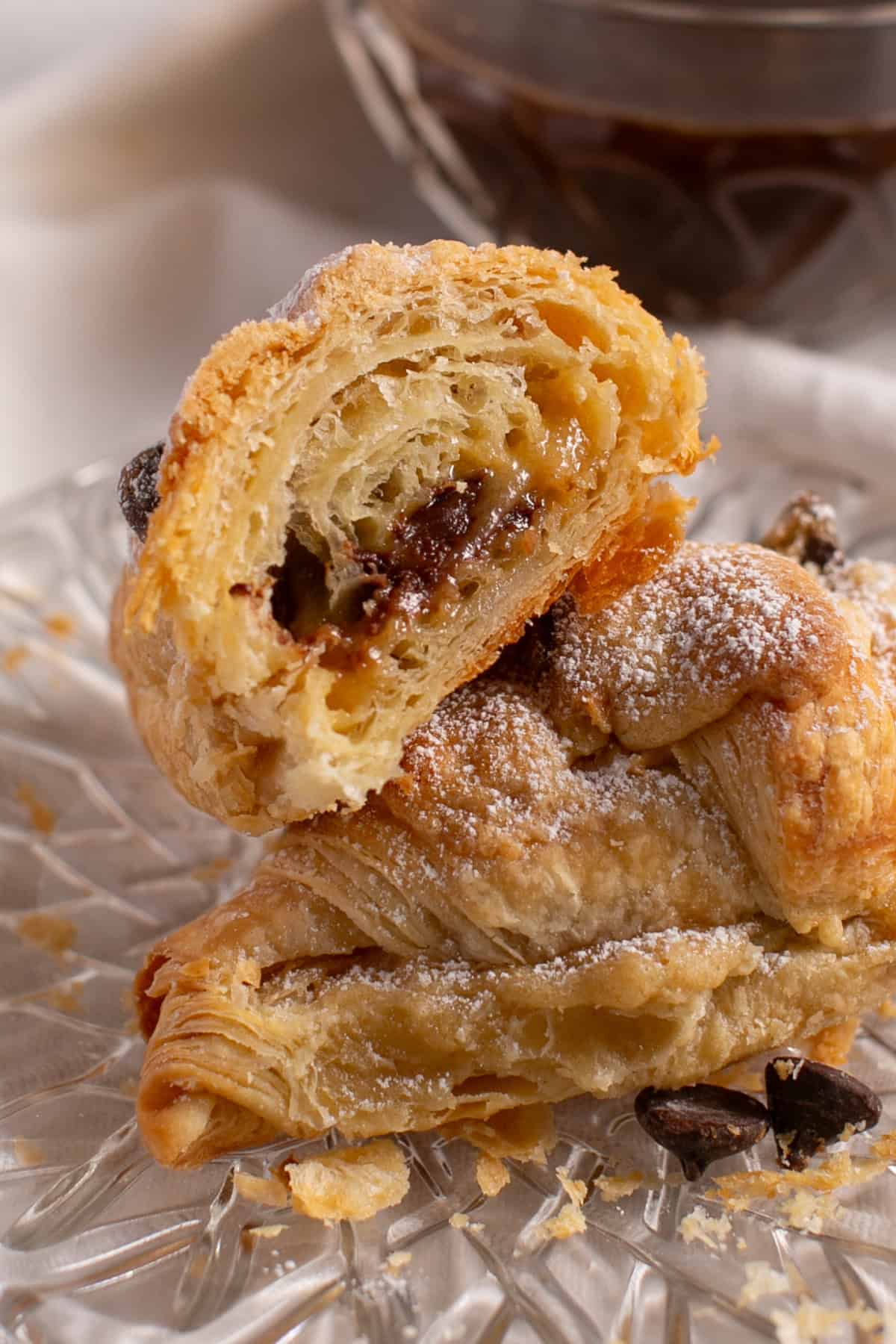 Chocolate Chip Cookie Croissant stacked on a plate.