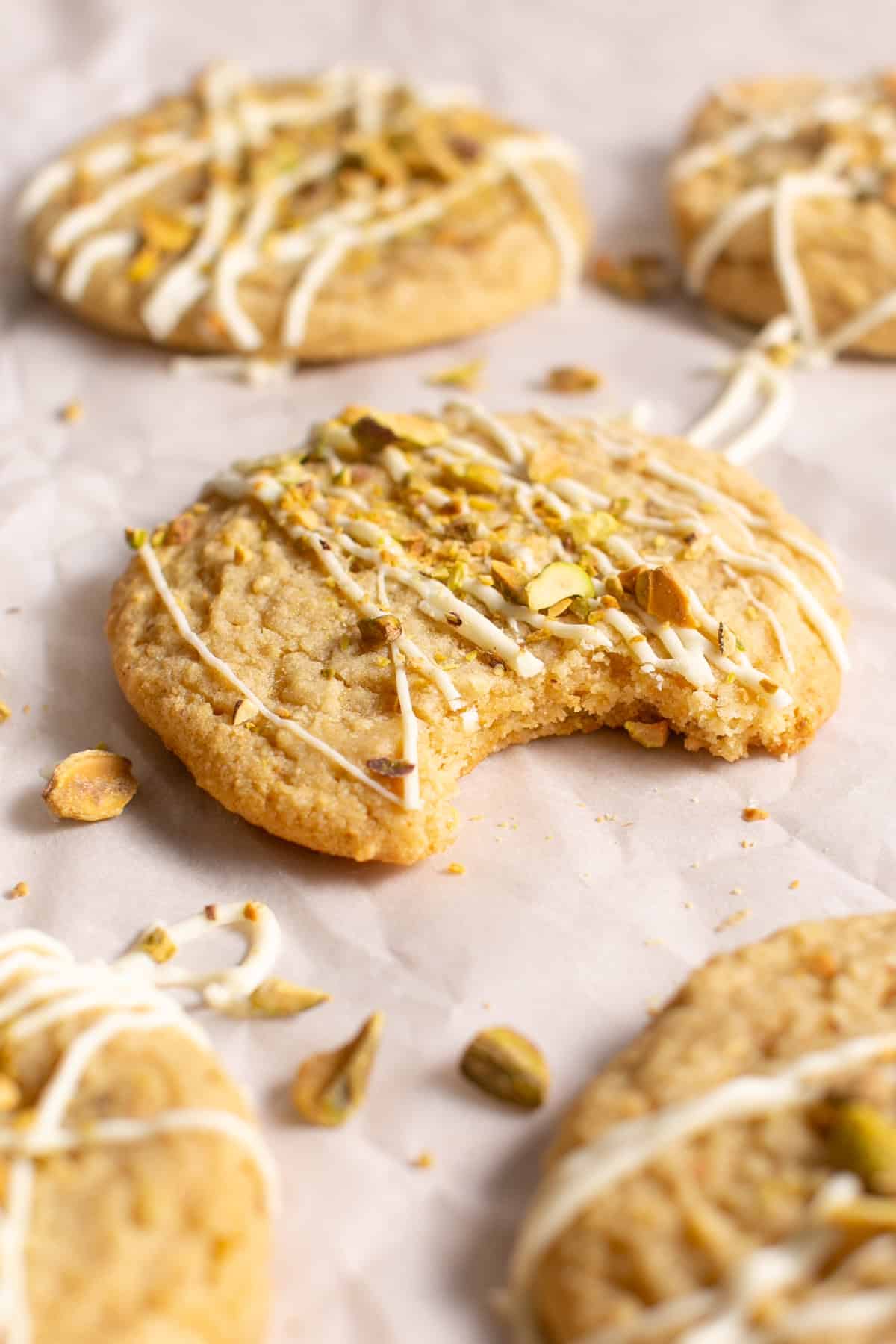 White Chocolate Pistachio Cookies with a bite missing. 