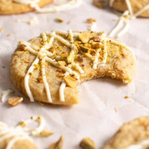 White Chocolate Pistachio Cookies with a bite taken out.
