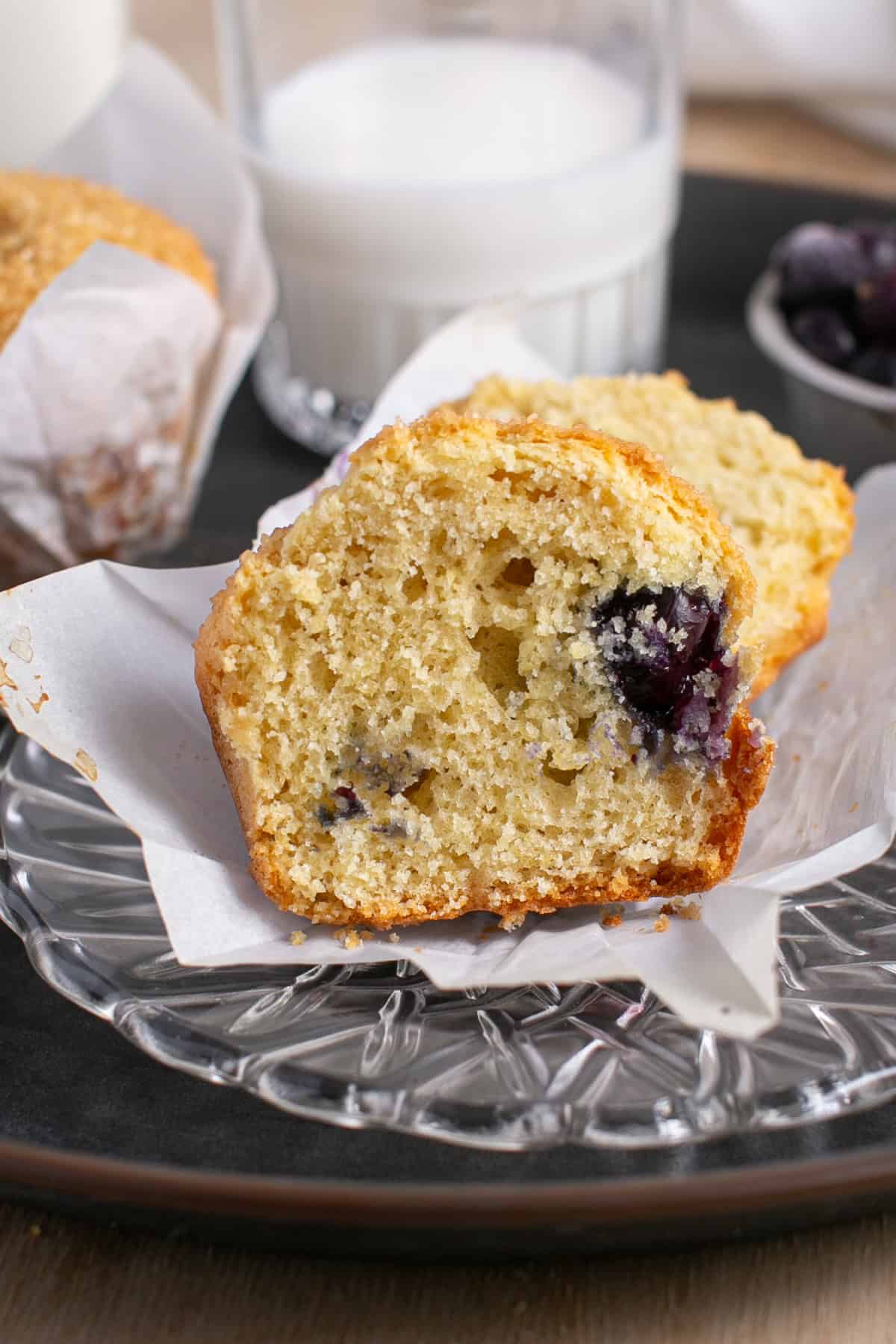 Single Serve Blueberry Muffin sitting by a glass of milk.