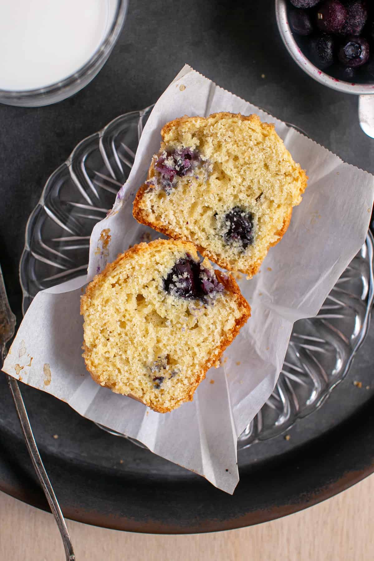Single Serve Blueberry Muffin cut in half on parchment paper. 