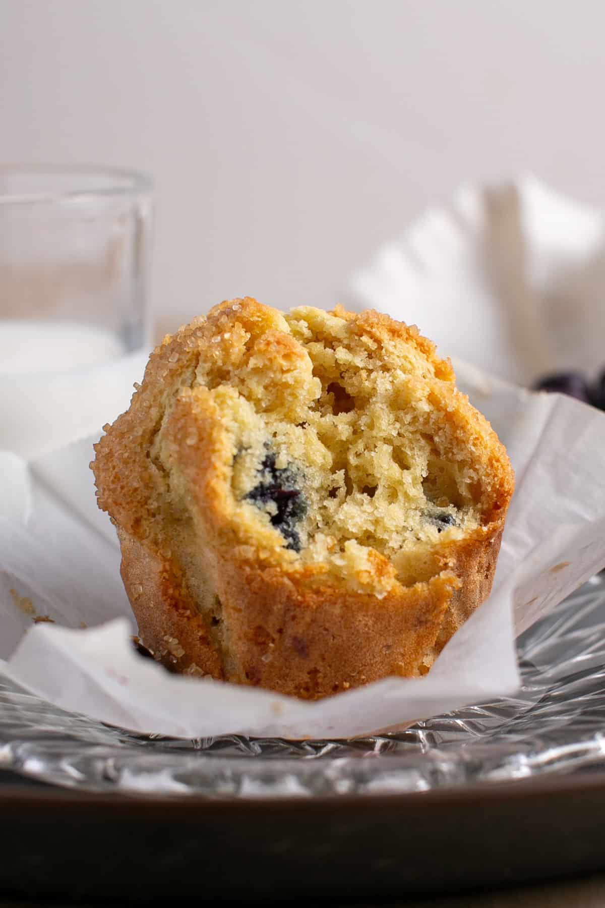 Single Serve Blueberry Muffin with a bite taken out. 