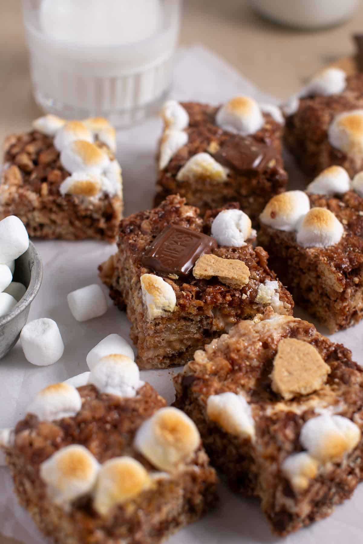 Browned Butter S'mores Rice Krispie Treats sitting by a bowl of marshmallows.