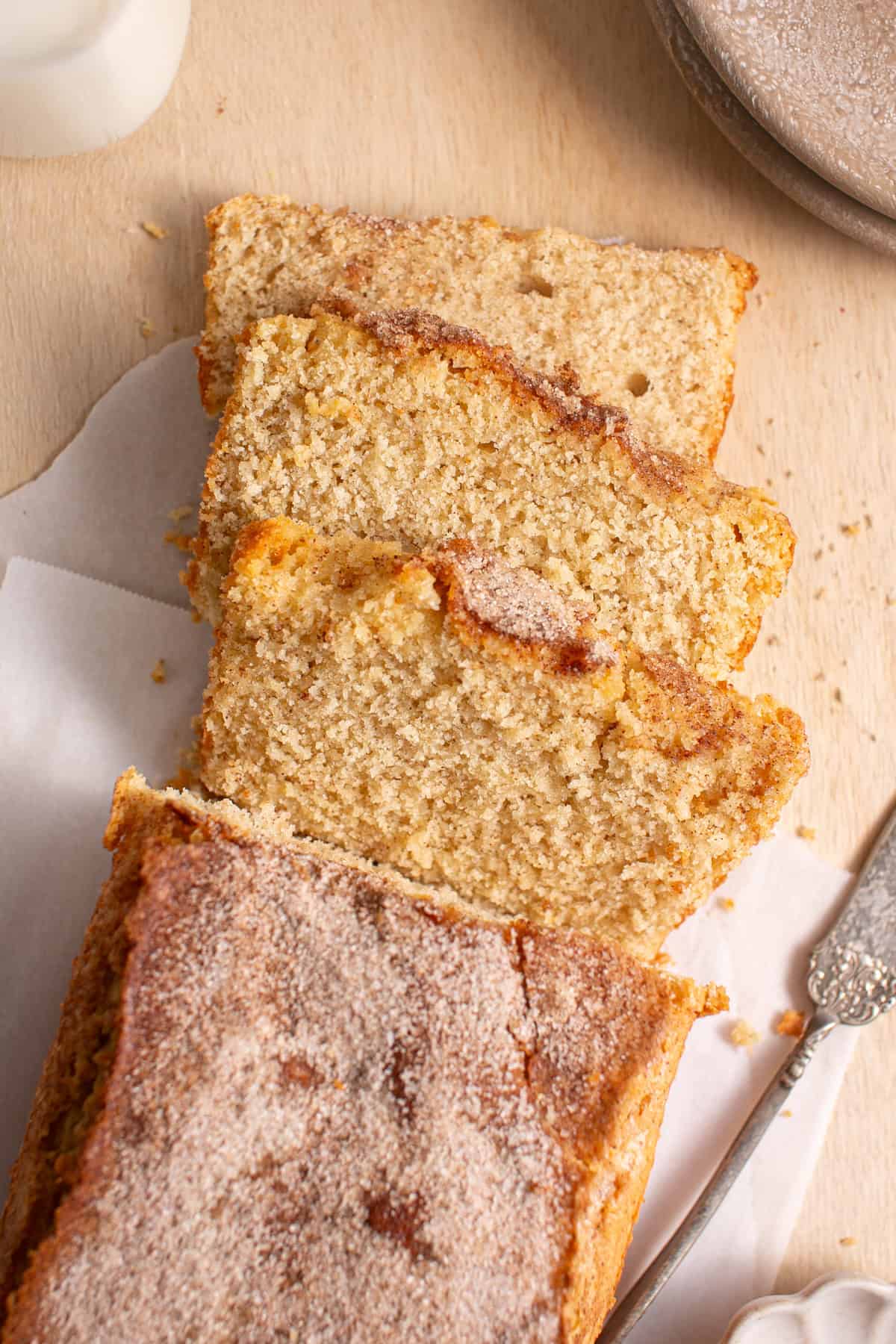 Vanilla Streusel Loaf cut into slices on parchment paper. 