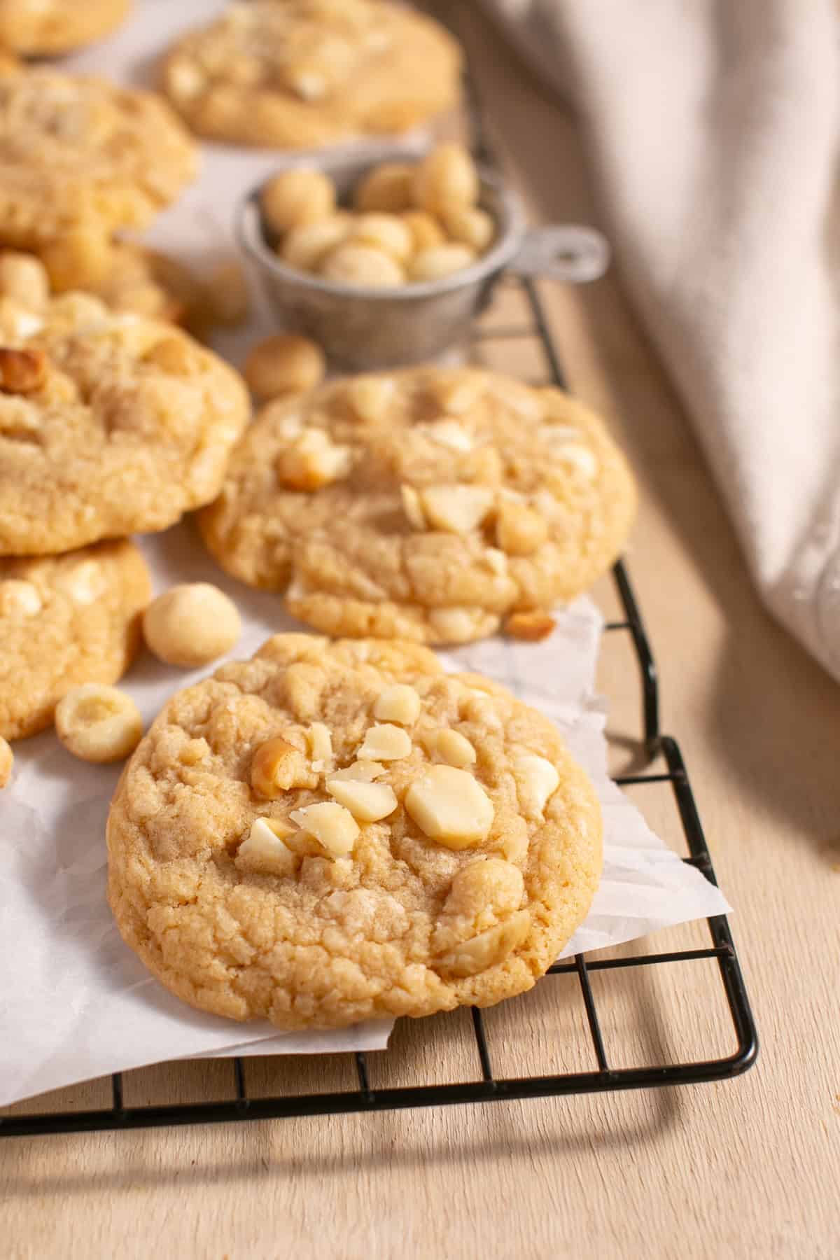 White Chocolate Macadamia Nut Cookies sitting on parchment paper. 