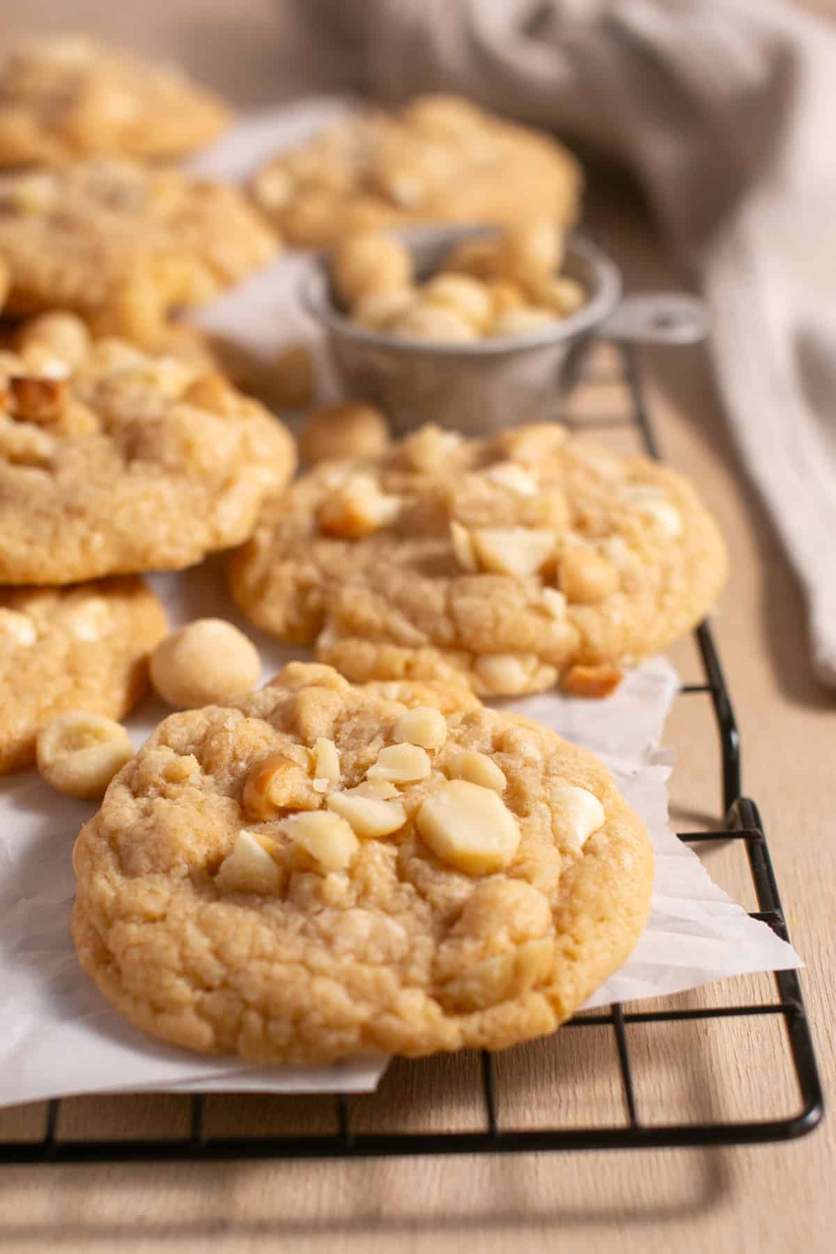 White Chocolate Macadamia Nut Cookies on a cooling rack with other cookies.