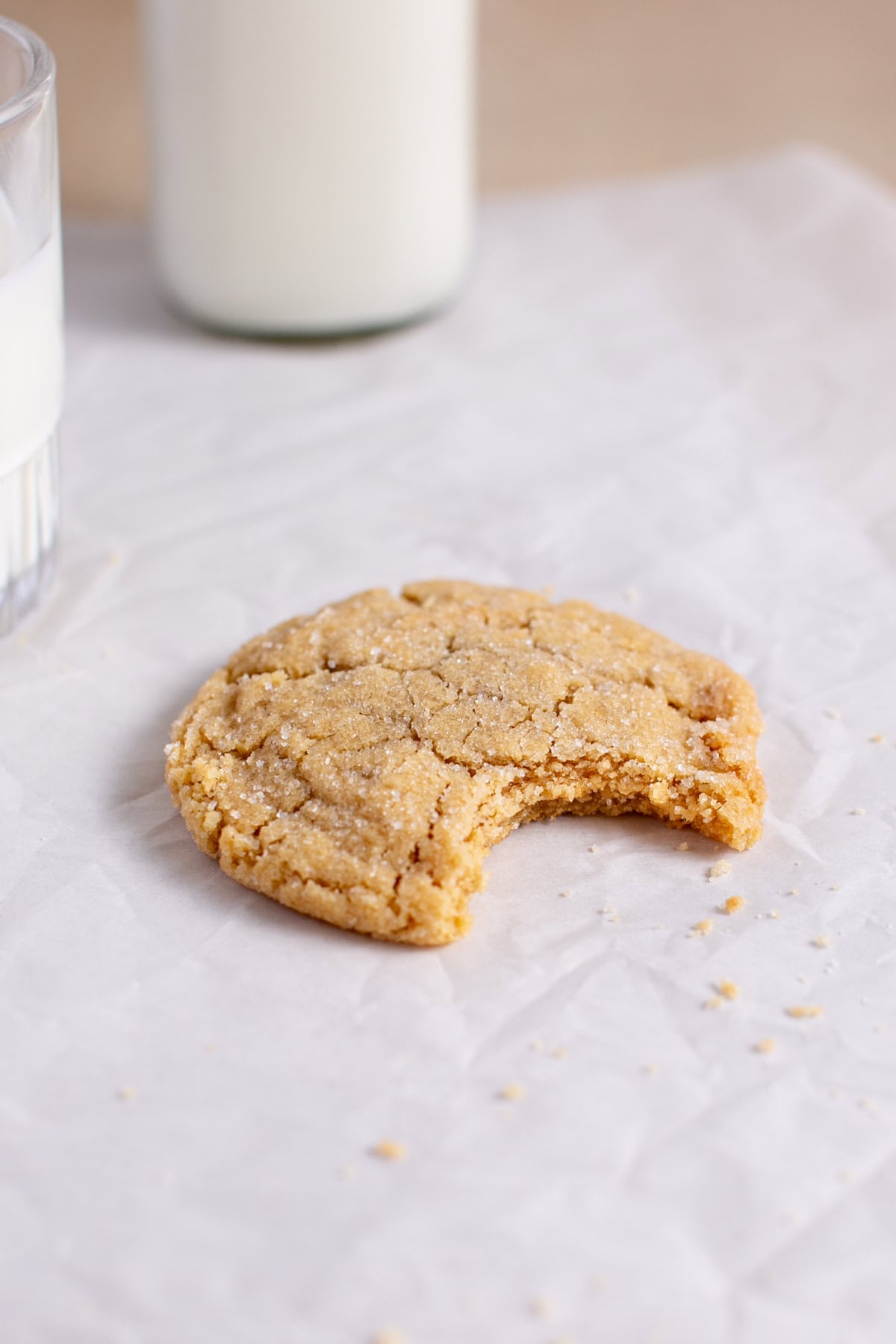 Single Serve Peanut Butter Cookie sitting by a cup of milk.
