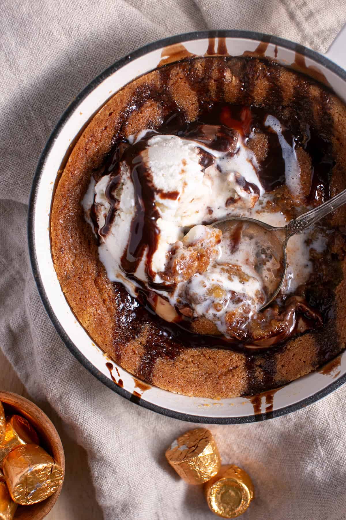 Skillet Chocolate Caramel Cookie with a drizzle of chocolate syrup. 