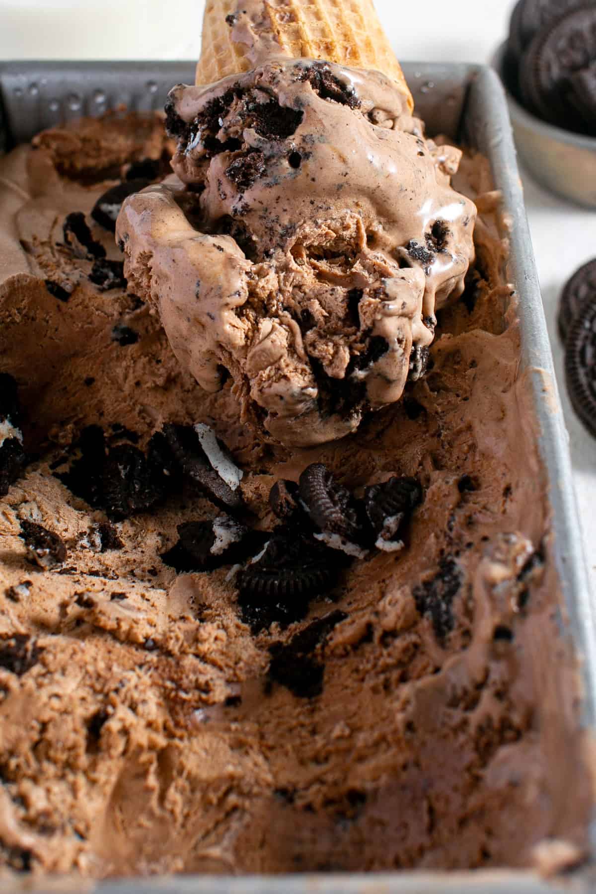 Coffee Ice Cream with a cone scooping some out. 