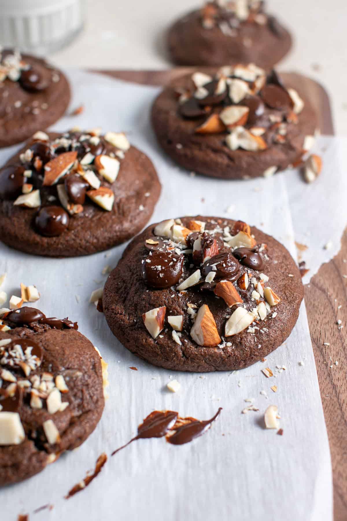 Almond Joy cookies on a cutting board with parchment paper. 