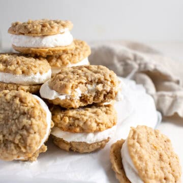 Ice cream sandwich cookies stacked on top of each other with a bite missing.