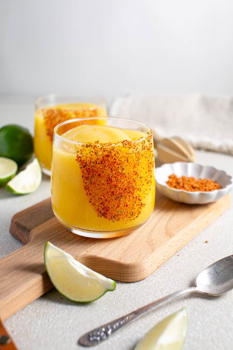 Mango Mocktail sitting by a lime juicer.