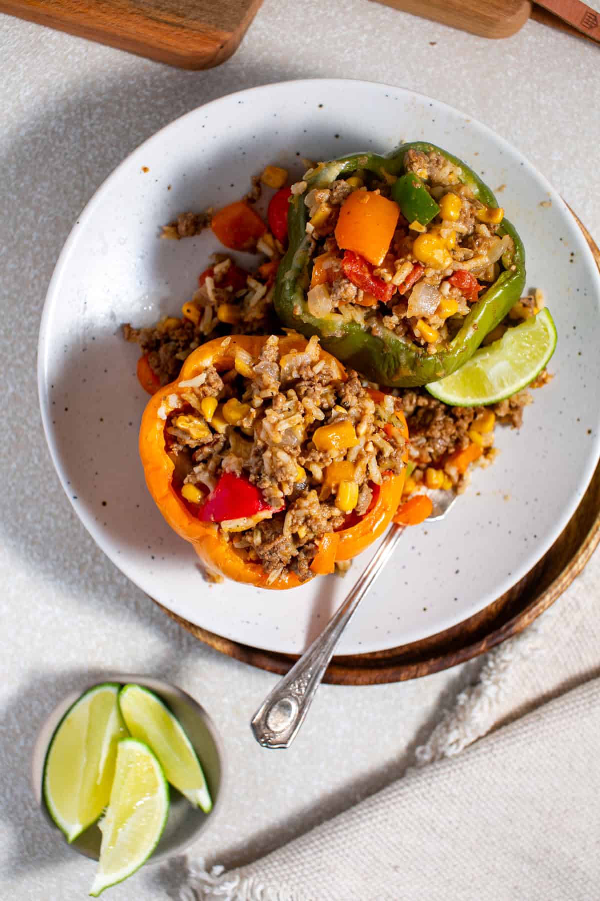 Stuffed Bell Peppers recipe sitting on a plate with a fork. 