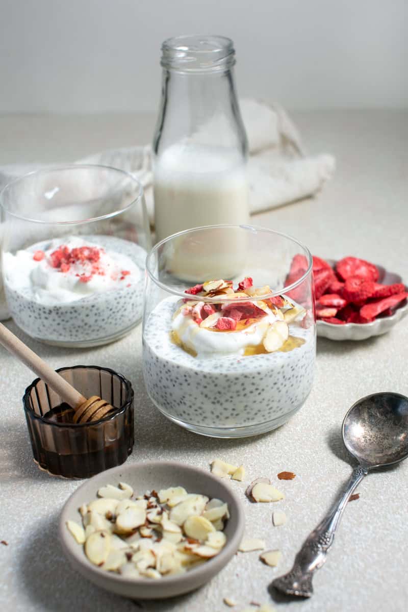 Chia seed pudding next to a glass of milk.