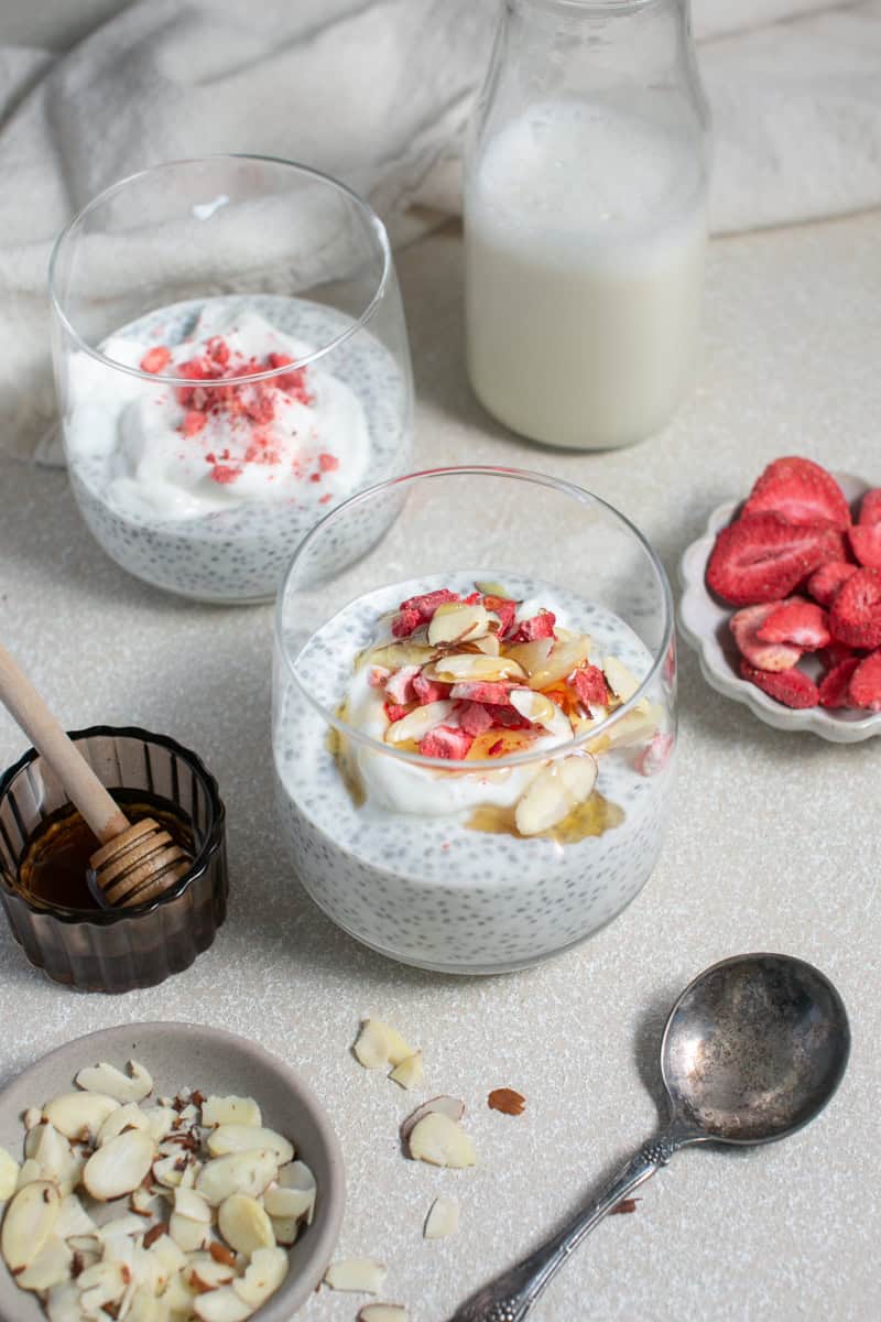 Chia seed pudding next to a glass of honey. 