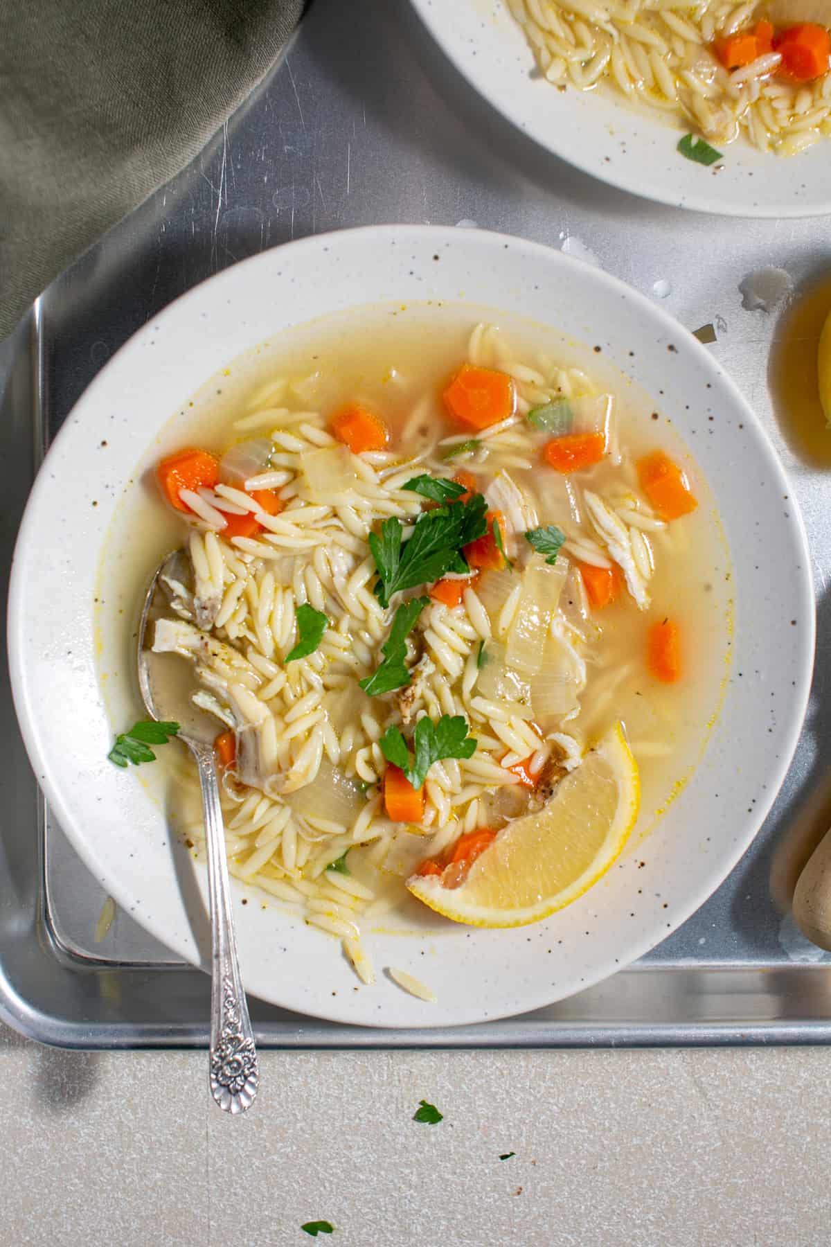 Lemon orzo soup sitting on a tray.